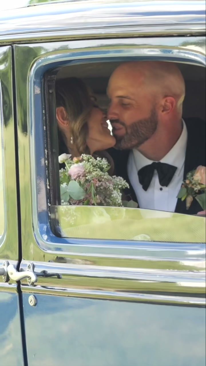 Romantic kiss through vintage car window