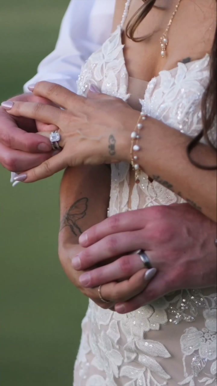 Interlocking hands and wedding rings detail
