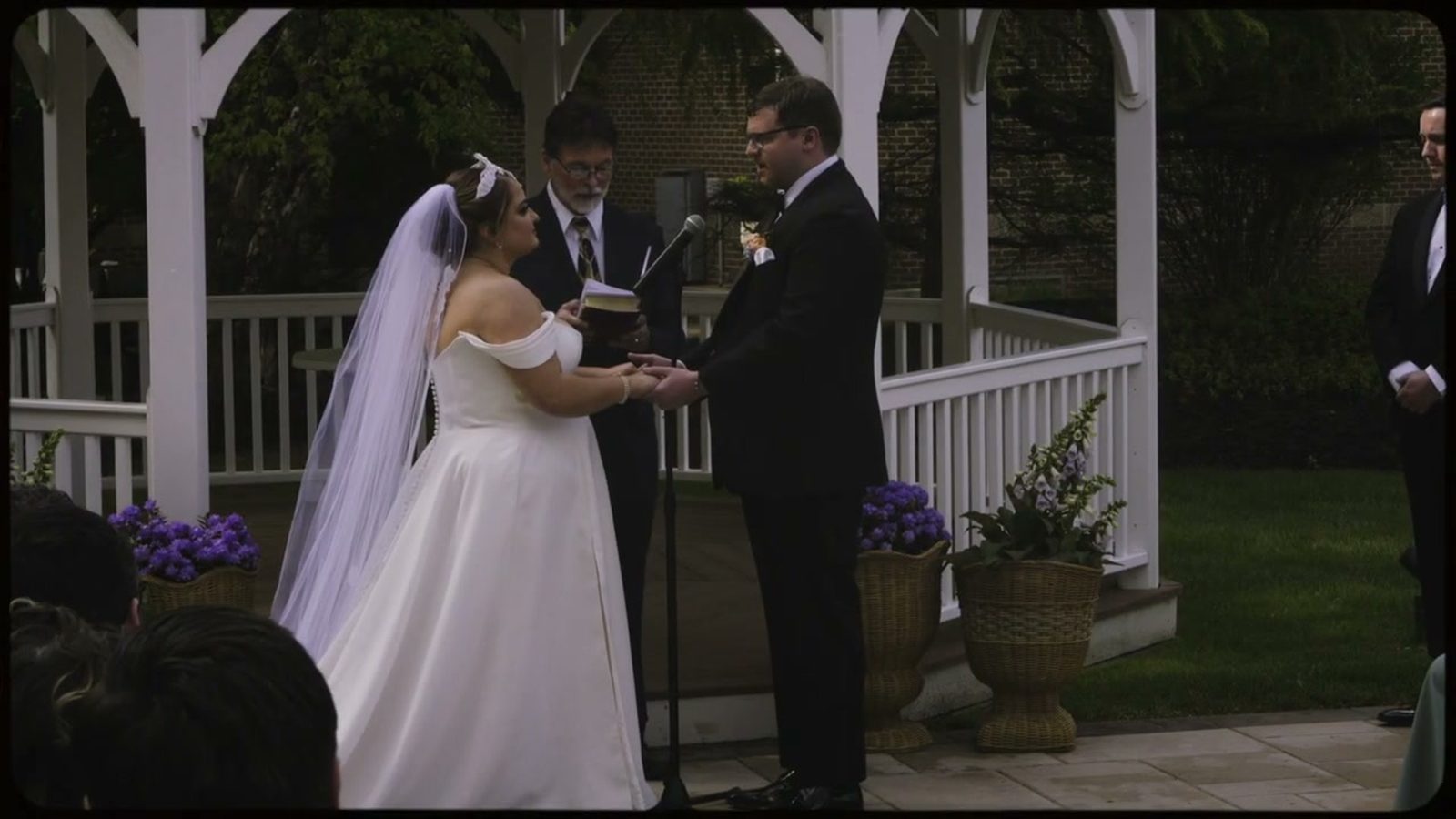 Wedding vow exchange at ceremony gazebo altar