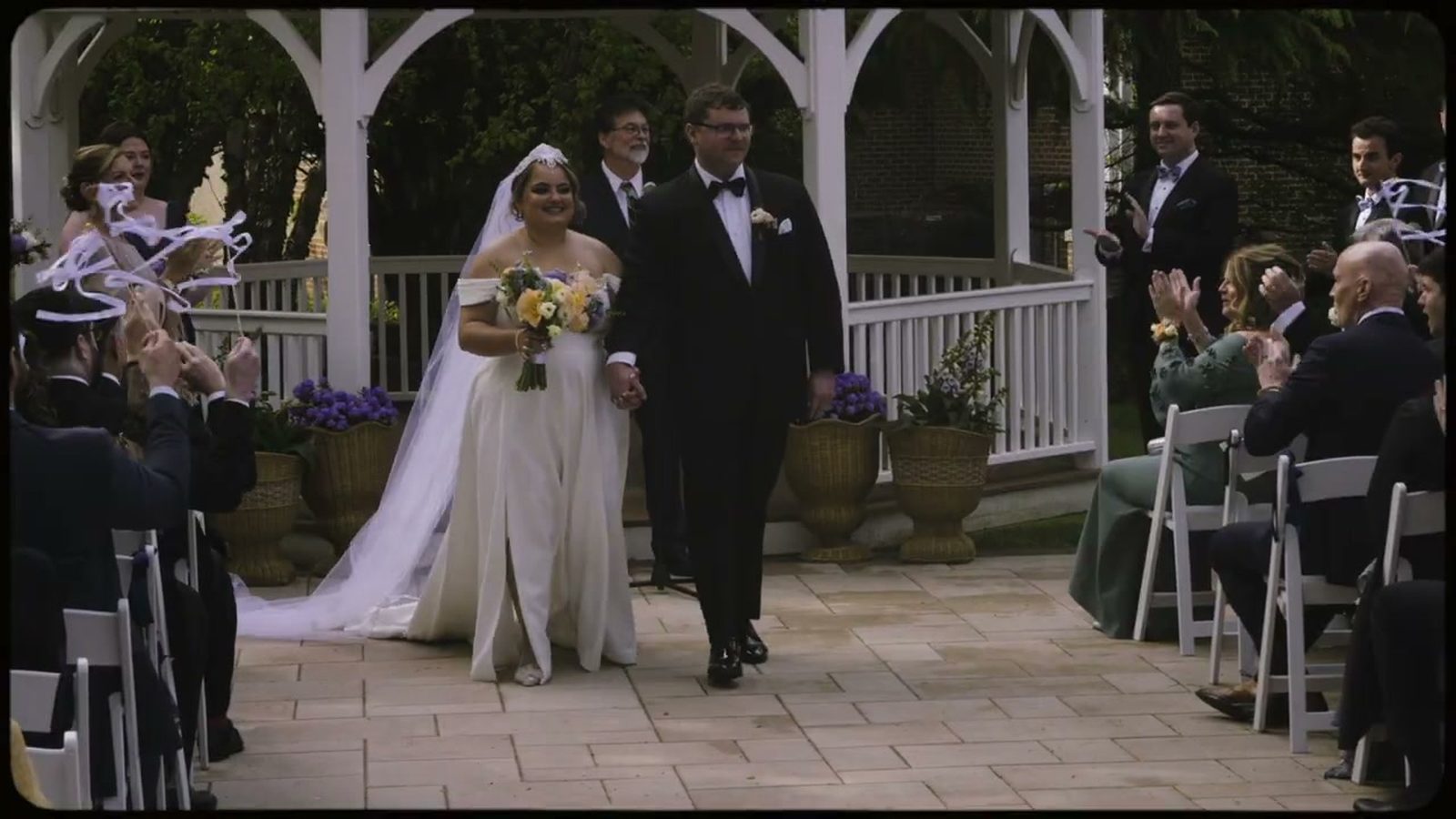 Newlyweds recessional celebration with ribbon wands